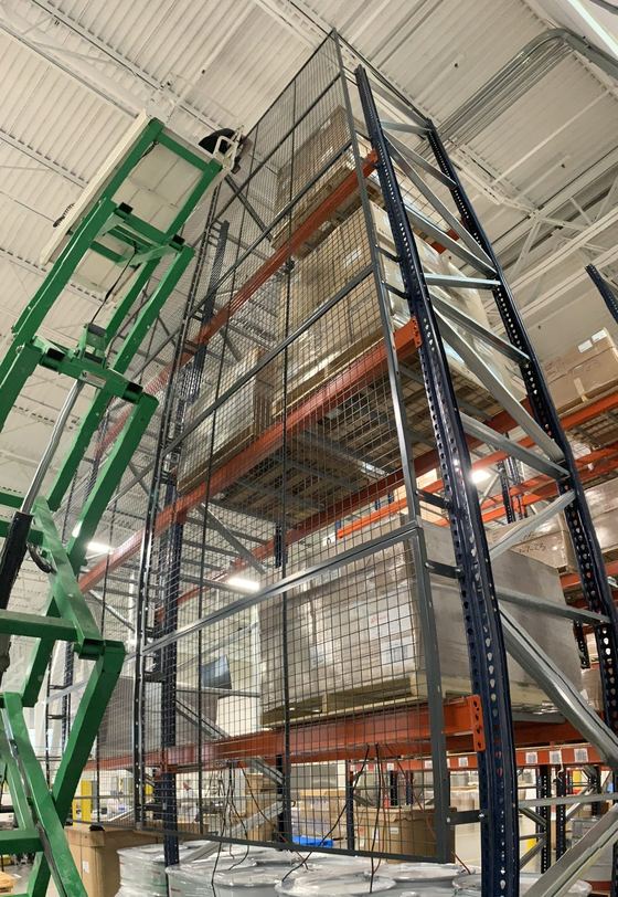 Rack bays enclosed with wire mesh security panels